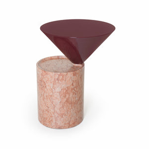 A modern side table featuring a glossy dark burgundy conical top mounted on a cylindrical pinkish-beige marble base, shown on a plain white background.