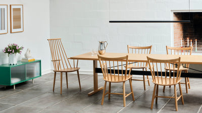 Dining area with wooden table and chairs in a modern kitchen setting.