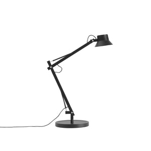 A matte black adjustable desk lamp with a circular base and articulated arm, shown on a plain white background.